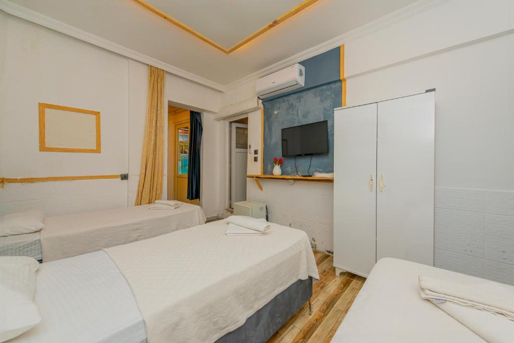 Postel nebo postele na pokoji v ubytování Aliş Hotel Fethiye