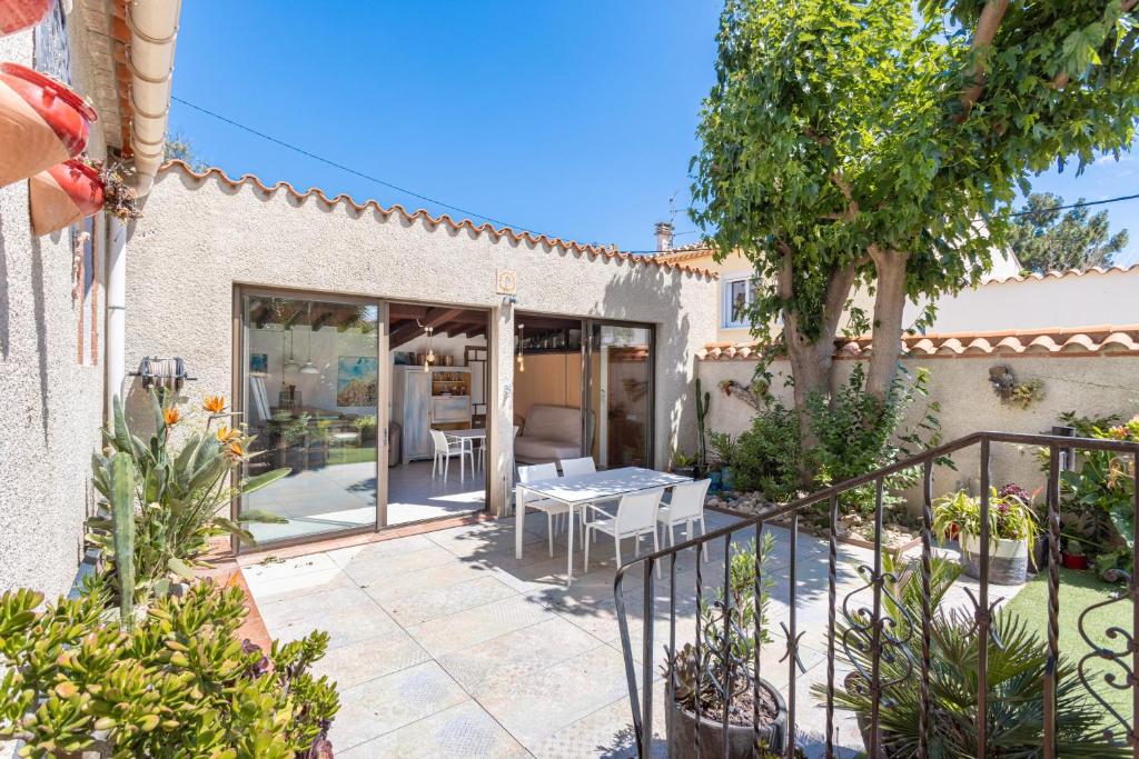 un patio d'une maison avec une table et des chaises dans l'établissement Can Lina, à Villemolaque