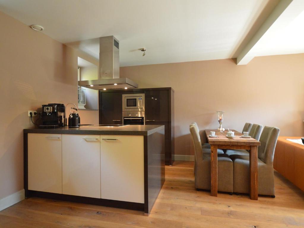 a kitchen and a dining room with a table and a counter at Stunning Holiday Home near Forest in Slenaken in Slenaken
