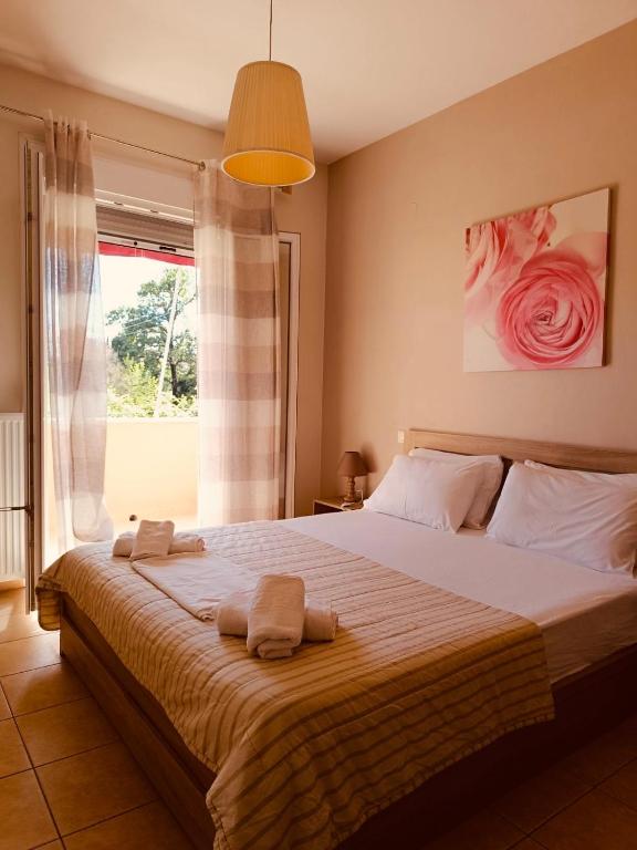 a bedroom with a large bed with towels on it at Rosa Viola in Corfu