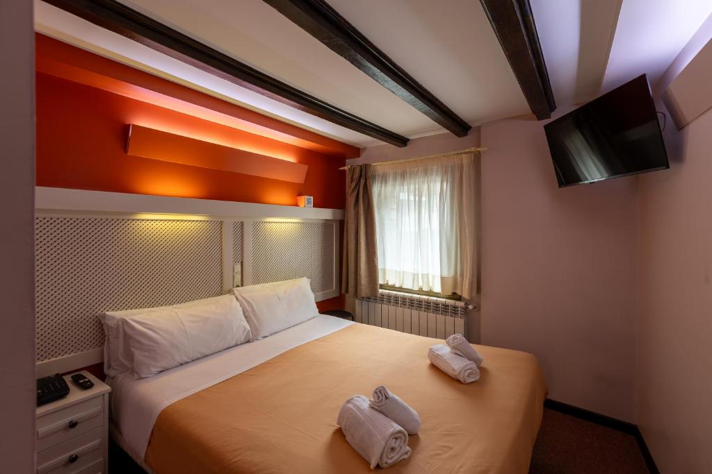 Postel nebo postele na pokoji v ubytování Hotel Micolau