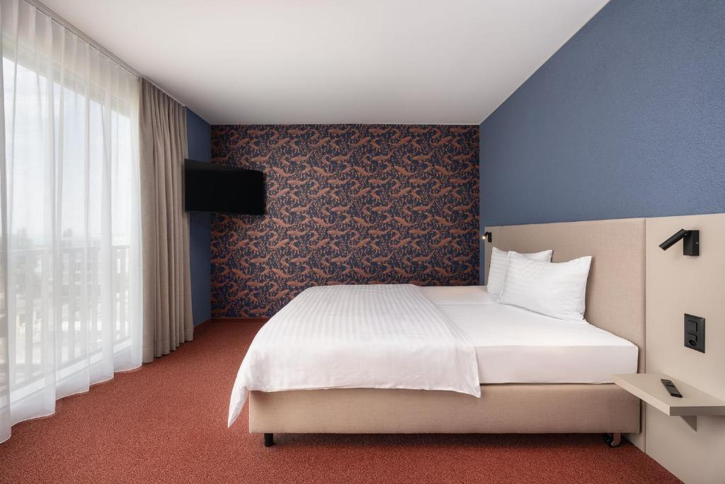 Postel nebo postele na pokoji v ubytování b-smart hotel Arbon