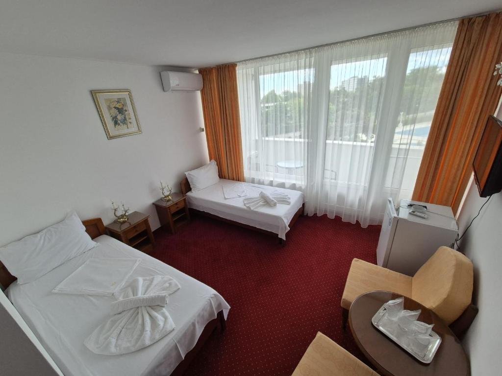 Postel nebo postele na pokoji v ubytování Hotel Scoica