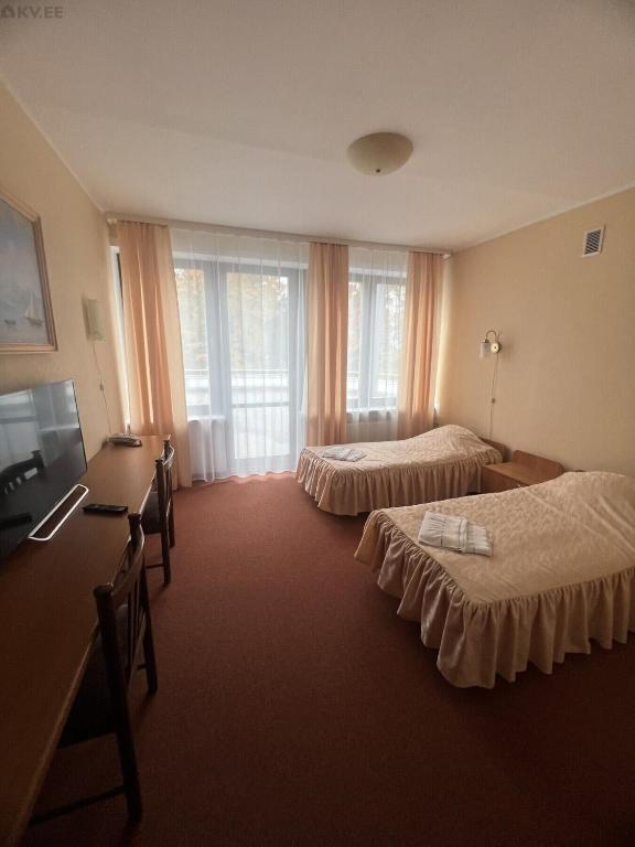 Postel nebo postele na pokoji v ubytování Narva-Jõesuu Beach Residence