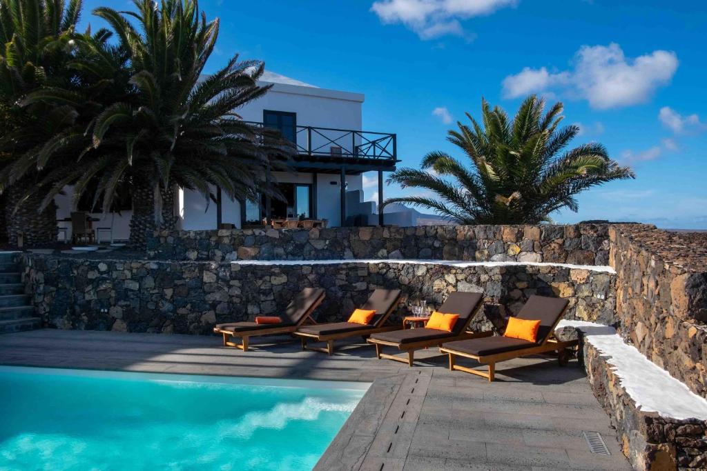a villa with a swimming pool next to a resort at Villa by the Sea in Mala