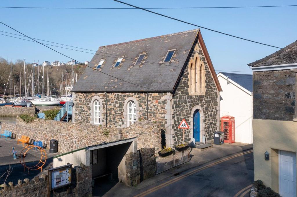 an old stone building with a blue door at Llanfor in Fishguard