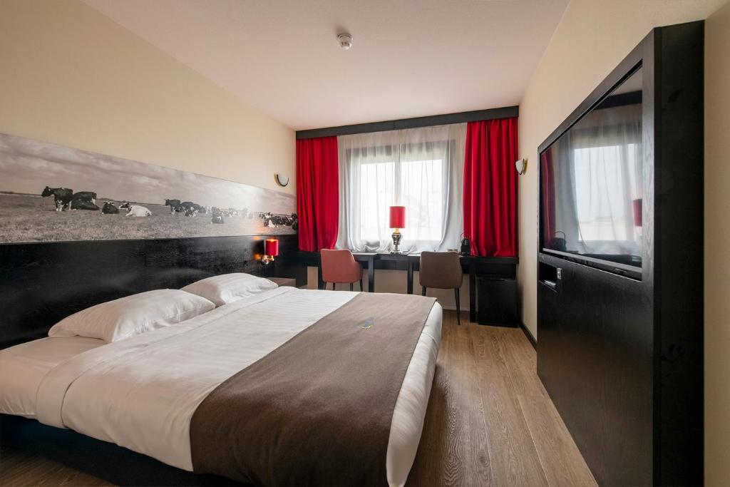 Postel nebo postele na pokoji v ubytování Bastion Hotel Den Haag Rijswijk
