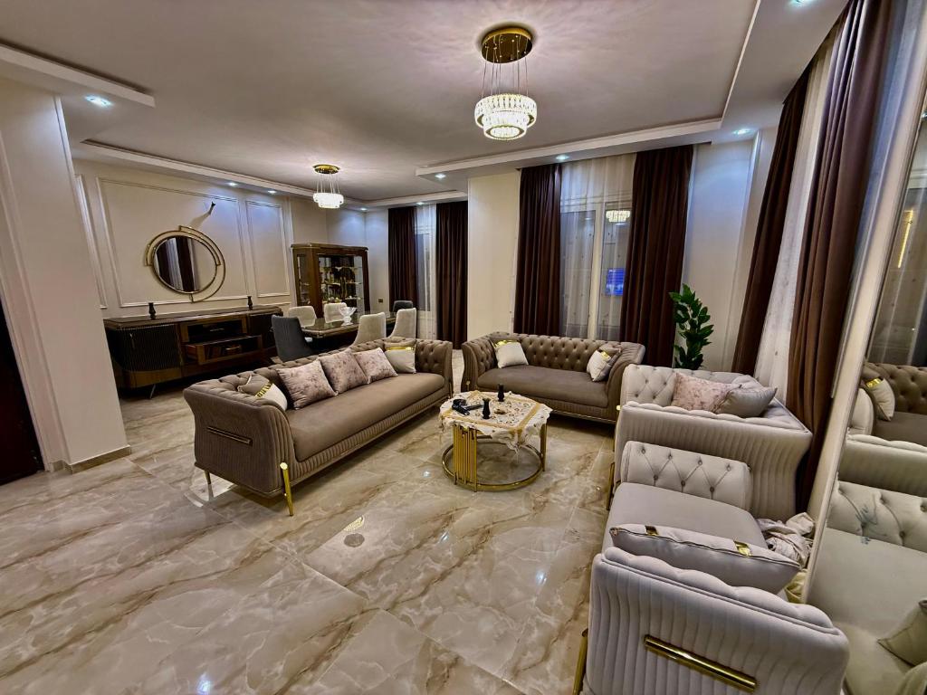 a large living room with couches and a table at House in 6th Of October