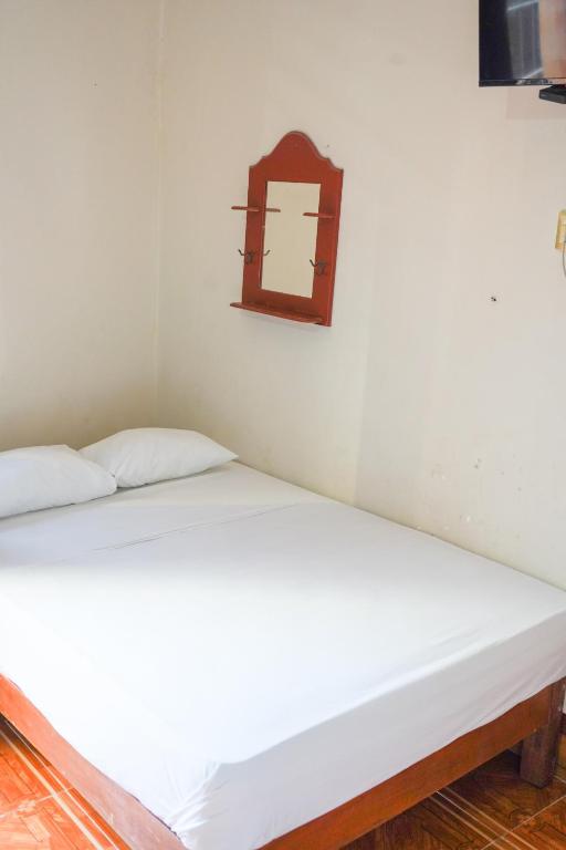 Postel nebo postele na pokoji v ubytování OYO Hotel El Conquistador