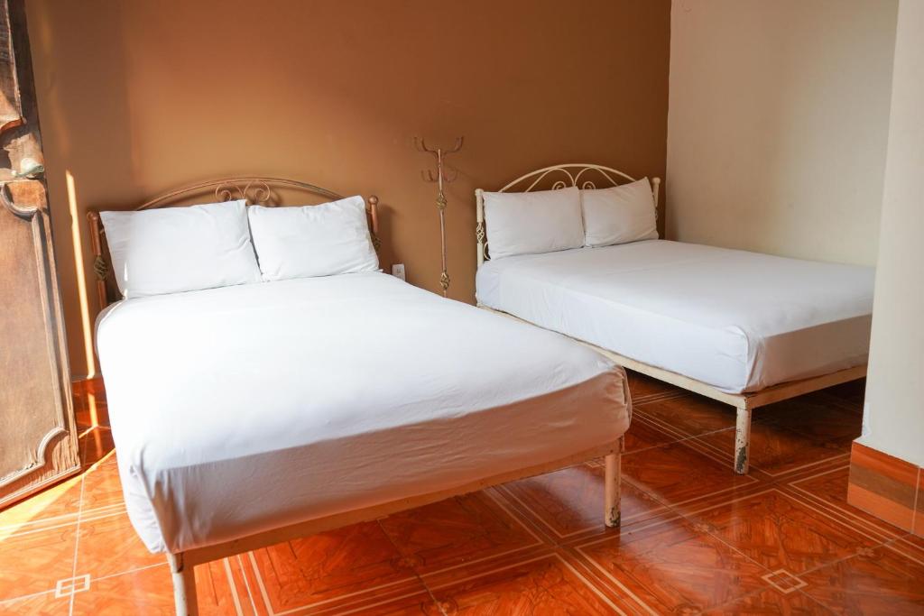 Postel nebo postele na pokoji v ubytování OYO Hotel El Conquistador