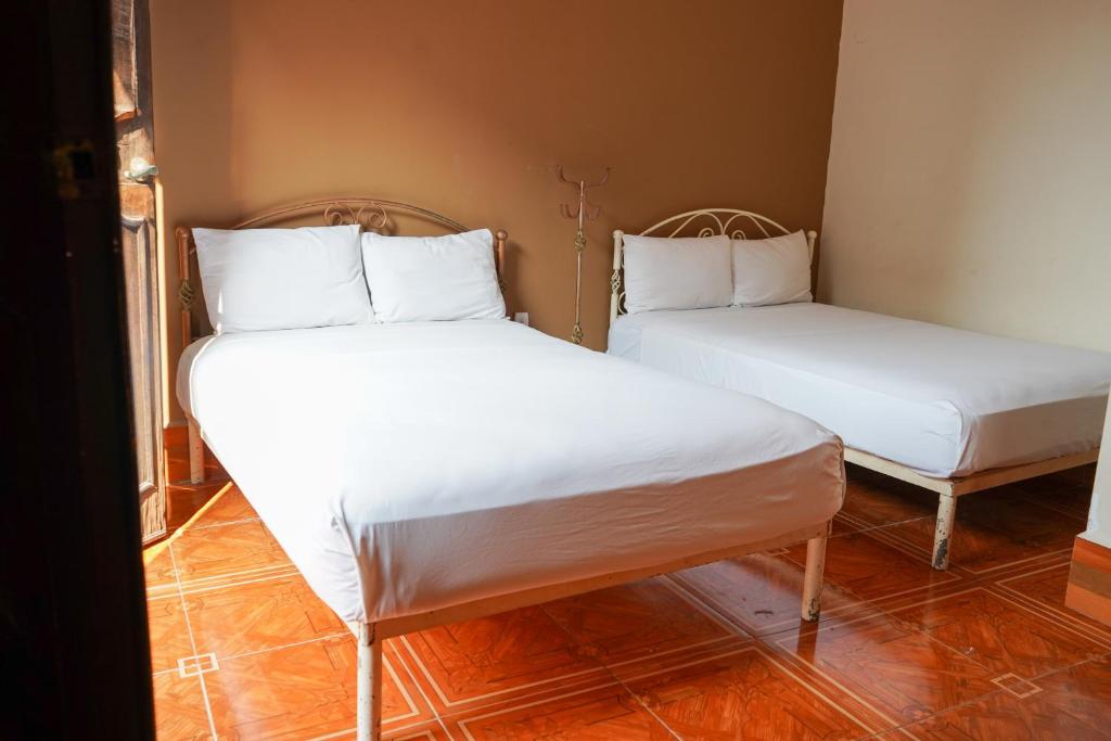 Postel nebo postele na pokoji v ubytování OYO Hotel El Conquistador
