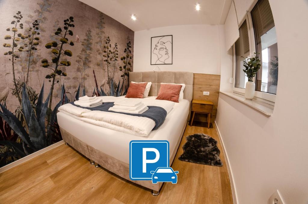 a bedroom with a bed and a mural of flowers at Ljubljana Urban Apartments - Quiet Stay & Free Parking in Ljubljana