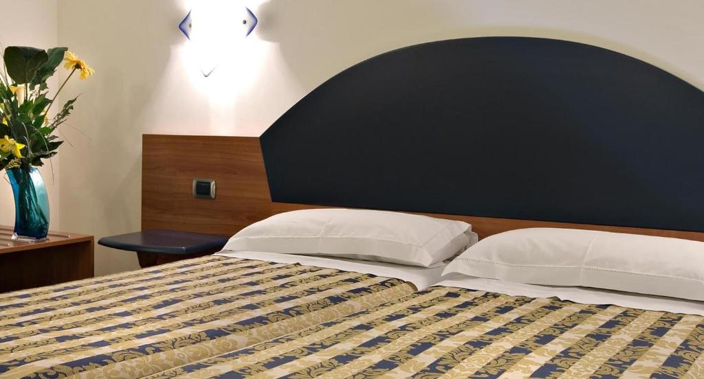 Postel nebo postele na pokoji v ubytování Hotel Marconi