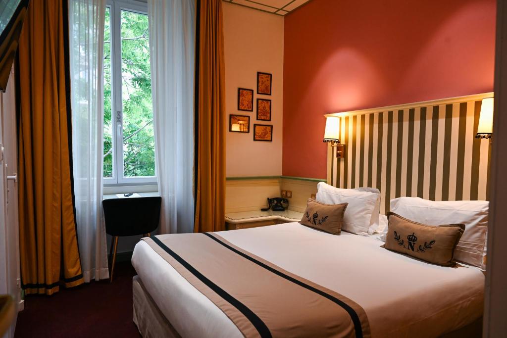 a hotel room with a bed and a window at Napoleon in Ajaccio