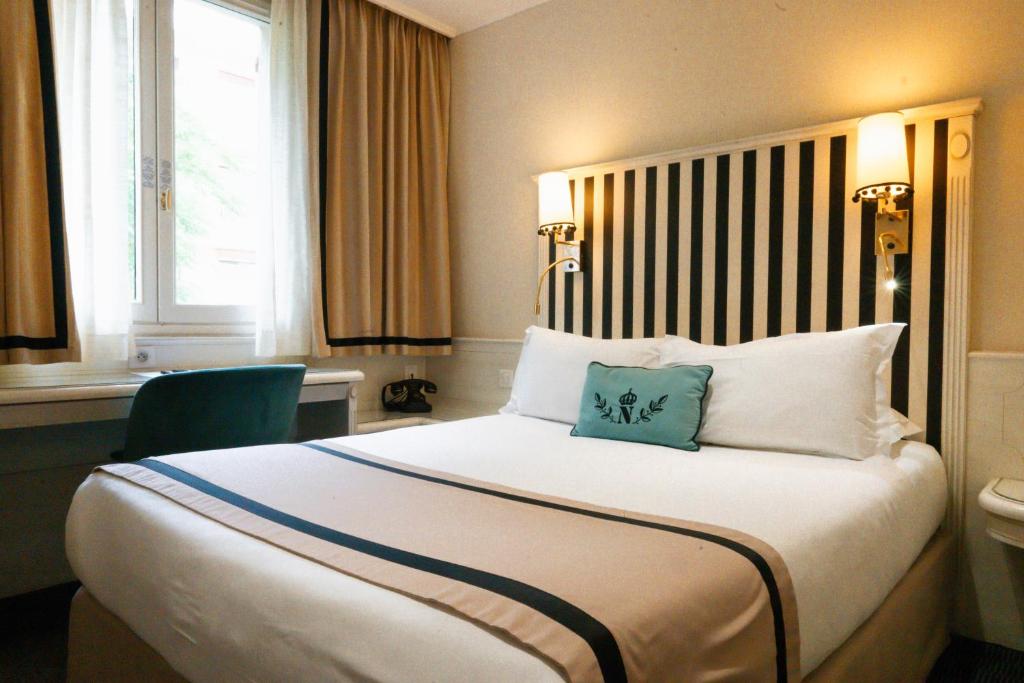 a hotel room with a large bed with two pillows at Napoleon in Ajaccio
