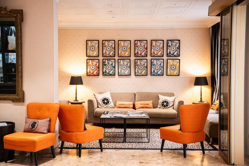 a living room with a couch and orange chairs at Napoleon in Ajaccio