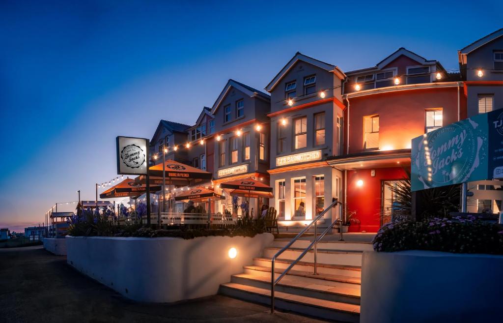 a building with a clock on the side of it at Tommy Jacks Beach Apartments in Bude