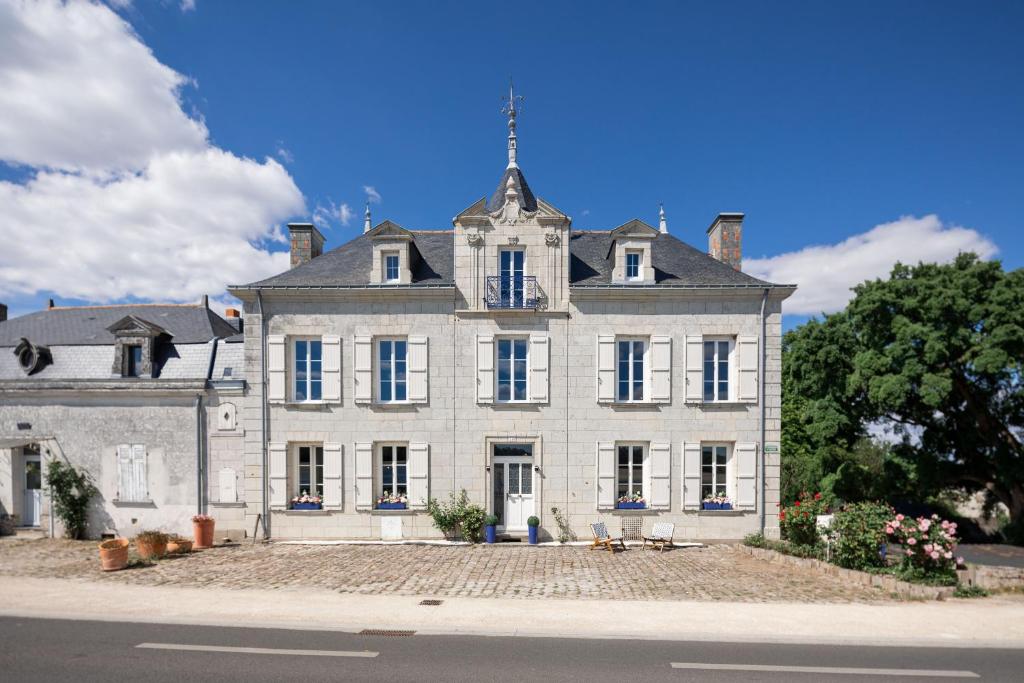 a large white house with a tower on top of it at Casa Mila Loire - L'expérience Hôtel & Spa - Angers Saumur in Saint-Mathurin