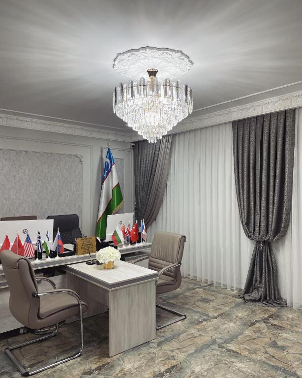an office with chairs and a table and a chandelier at Art Apart Residence in Tashkent