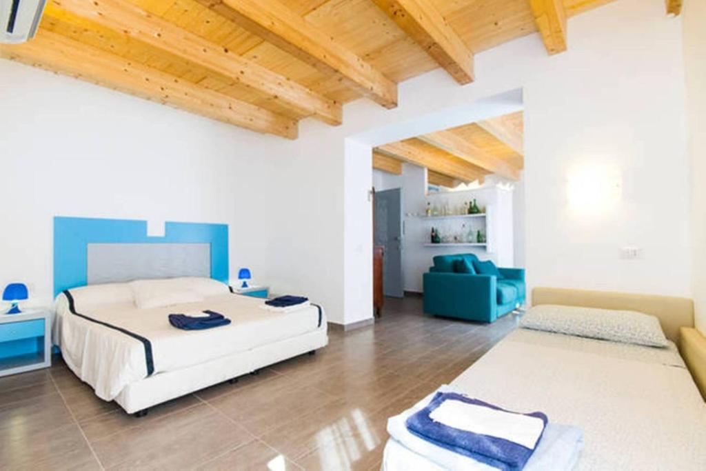 カルロフォルテにあるResidenza Cuntinのベッドルーム1室(ベッド2台、青いソファ付)