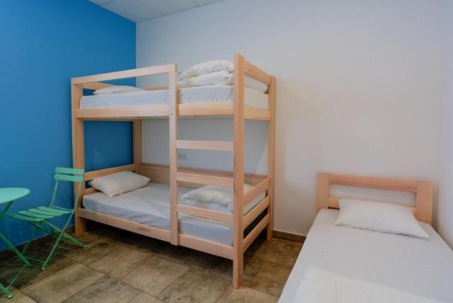 a bedroom with a bed and a desk at Comfort Hotel & Hostel in Zaporozhye