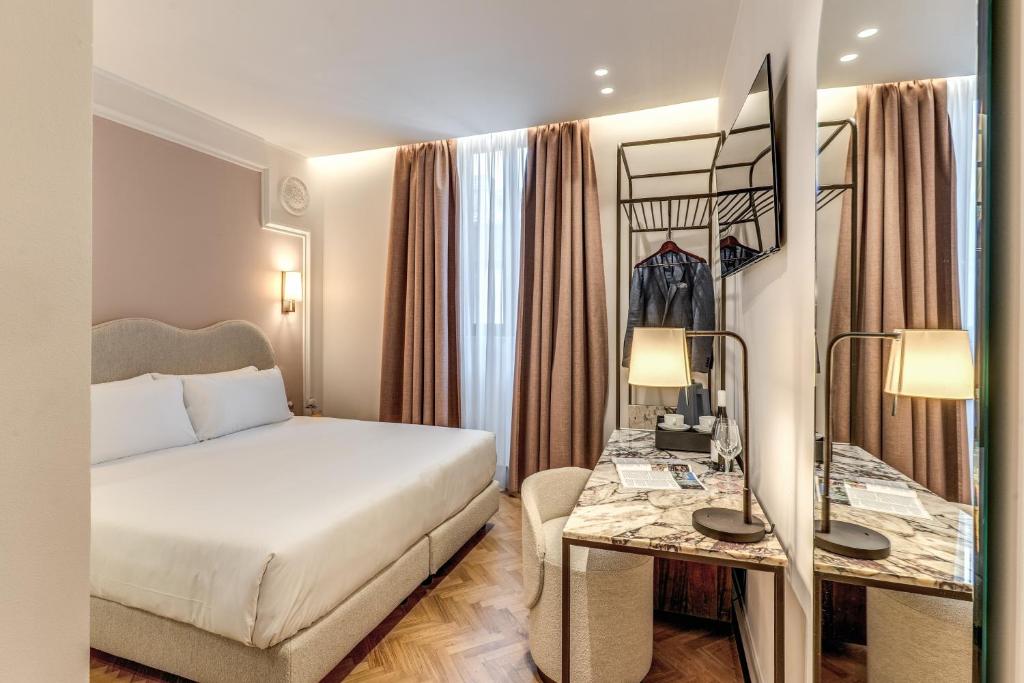 Postel nebo postele na pokoji v ubytování Hotel Fori Imperiali