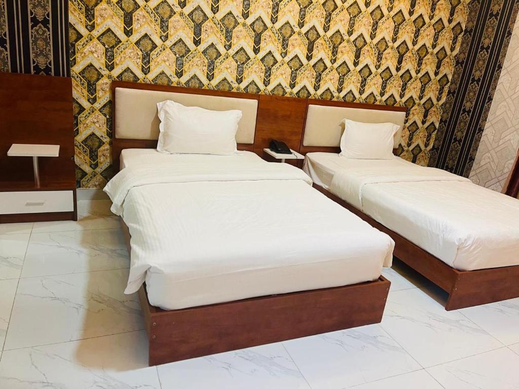 Postel nebo postele na pokoji v ubytování Grand Inn Hotel By Wanasa
