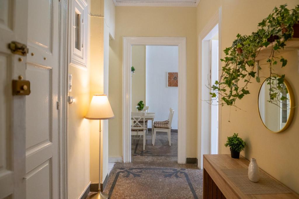 a hallway with a door leading to a dining room at The Psyri Collection in Athens