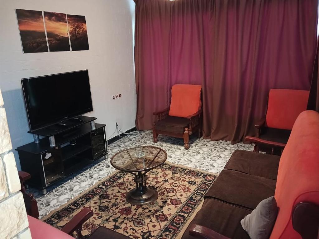 A television and/or entertainment centre at Maamoura Beach Zahraa Apartment 9/206