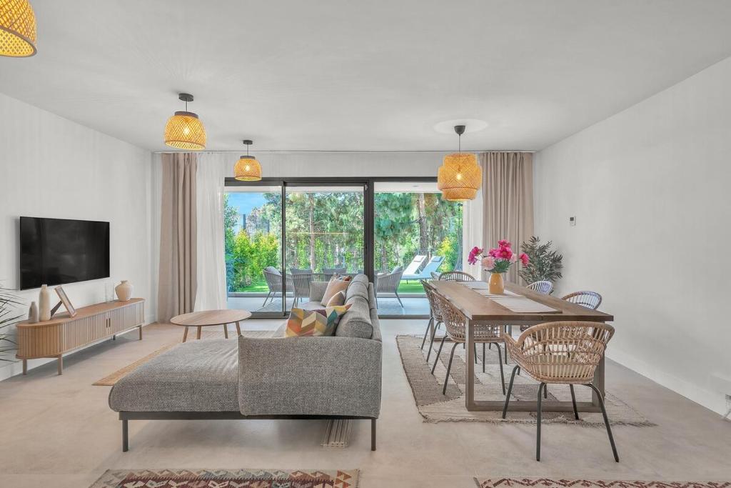 a living room with a couch and a table at Townhouse Eden Golf Chaparral in Málaga