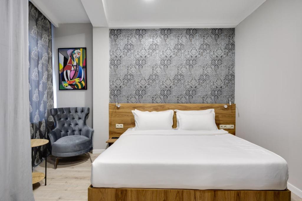 Postel nebo postele na pokoji v ubytování Regraph Hotel