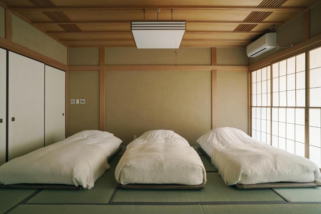 Postel nebo postele na pokoji v ubytování 赤城宿 珠蕾山荘-shurai-