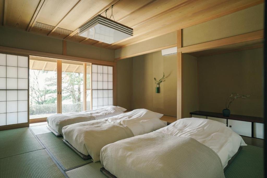 Postel nebo postele na pokoji v ubytování 赤城宿 珠蕾山荘-shurai-