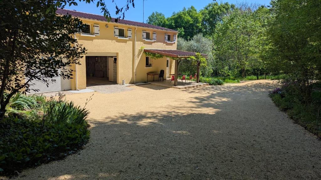 a driveway leading to a house with a garage at Terres du Milieu in Saint-Mayme-de-Pereyol
