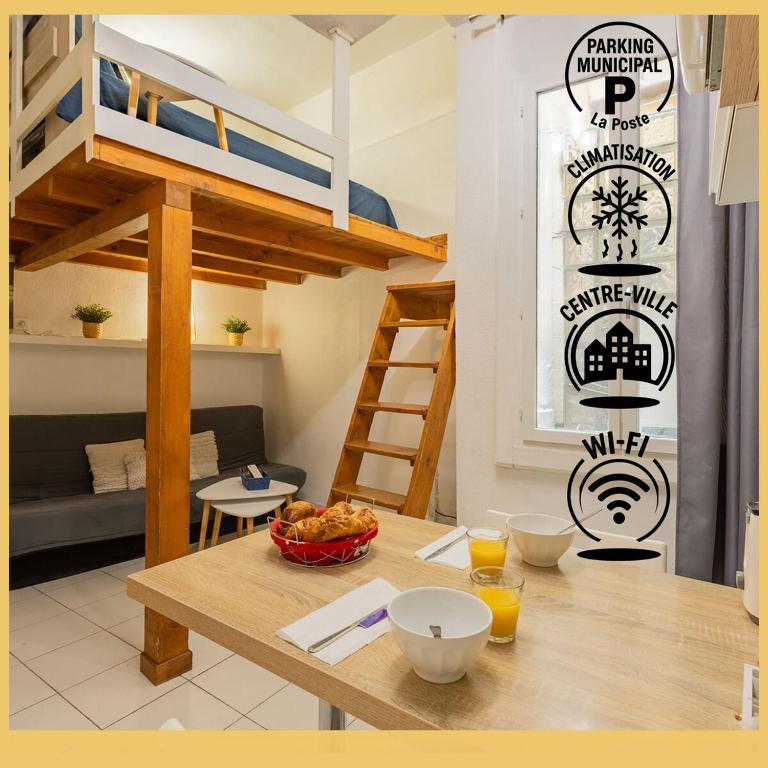 Cette chambre comprend une table et des lits superposés. dans l'établissement Studio GIGI 50 m mer climatisation plein centre, à Palavas-les-Flots