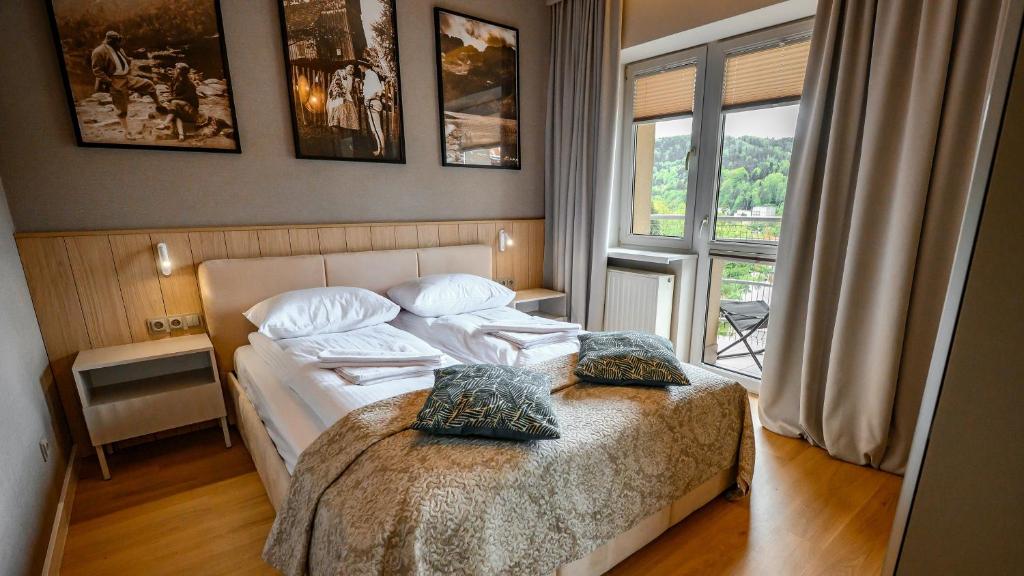 Posteľ alebo postele v izbe v ubytovaní Apartamenty Sun & Snow Krynica Zdrój Pułaskiego