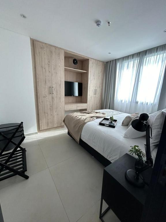 Postel nebo postele na pokoji v ubytování Divina Tower Apart Hotel