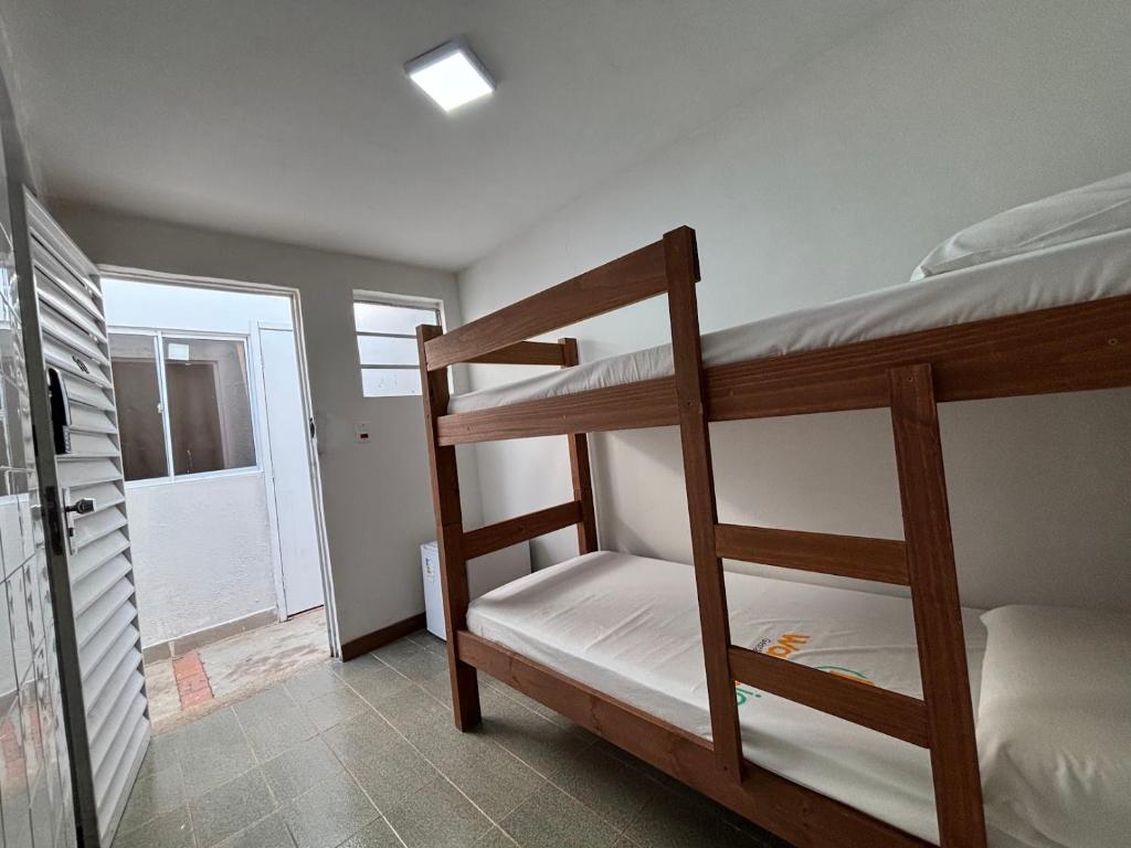 Postel nebo postele na pokoji v ubytování Wafeh Pampulha Suítes
