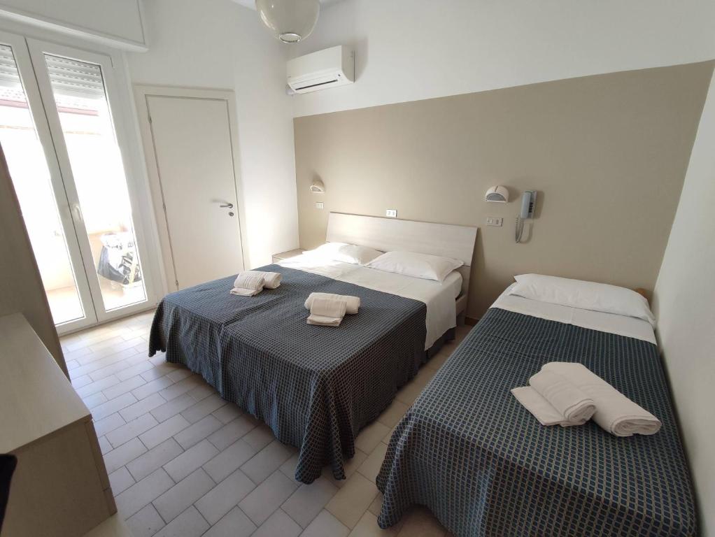 Postel nebo postele na pokoji v ubytování Hotel Atlas