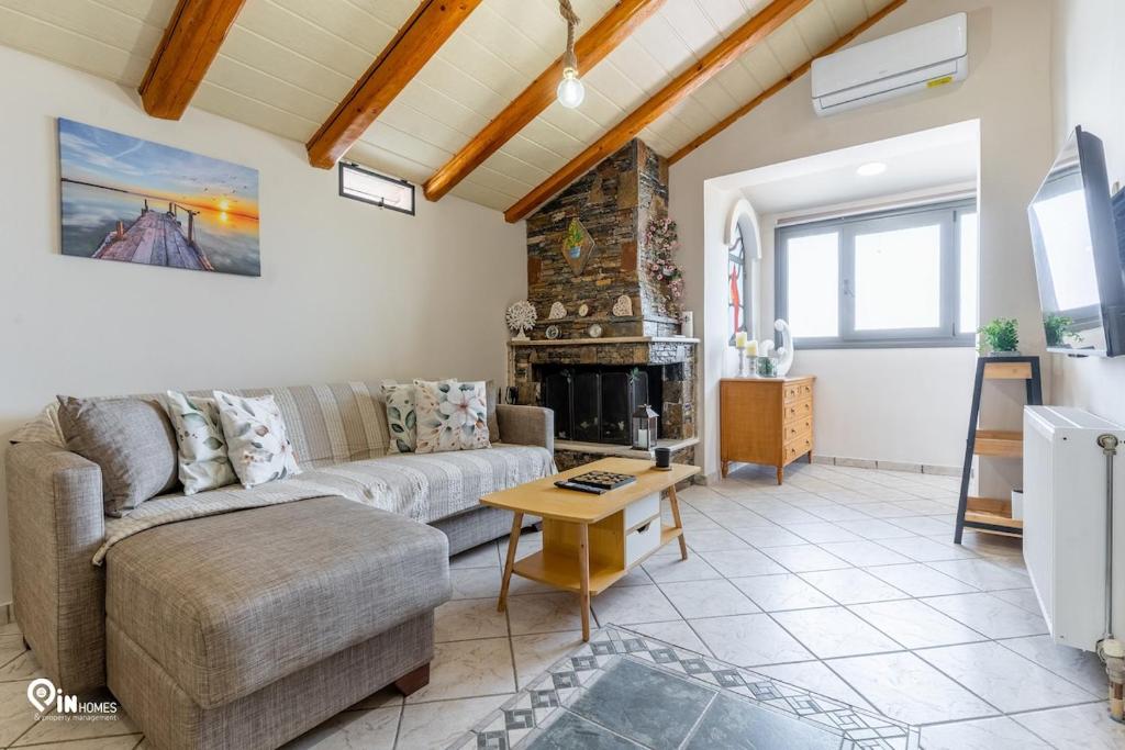 a living room with a couch and a fireplace at Four 4Season - Beach Access & Amazing View Retreat in Vraná