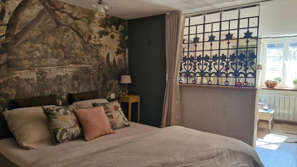 - une chambre avec un lit et un mur orné d'une fresque murale dans l'établissement Un monde à part avec jardin à 3 min de la Ferté et 40 min de Paris en TER, à Reuil-en-Brie