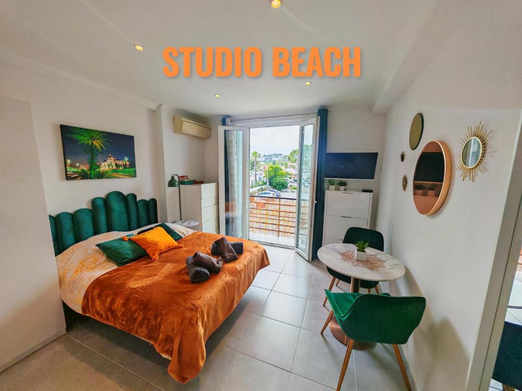 une chambre avec un lit et un panneau indiquant studio beach dans l'établissement Studio Beach, à Villeneuve-Loubet