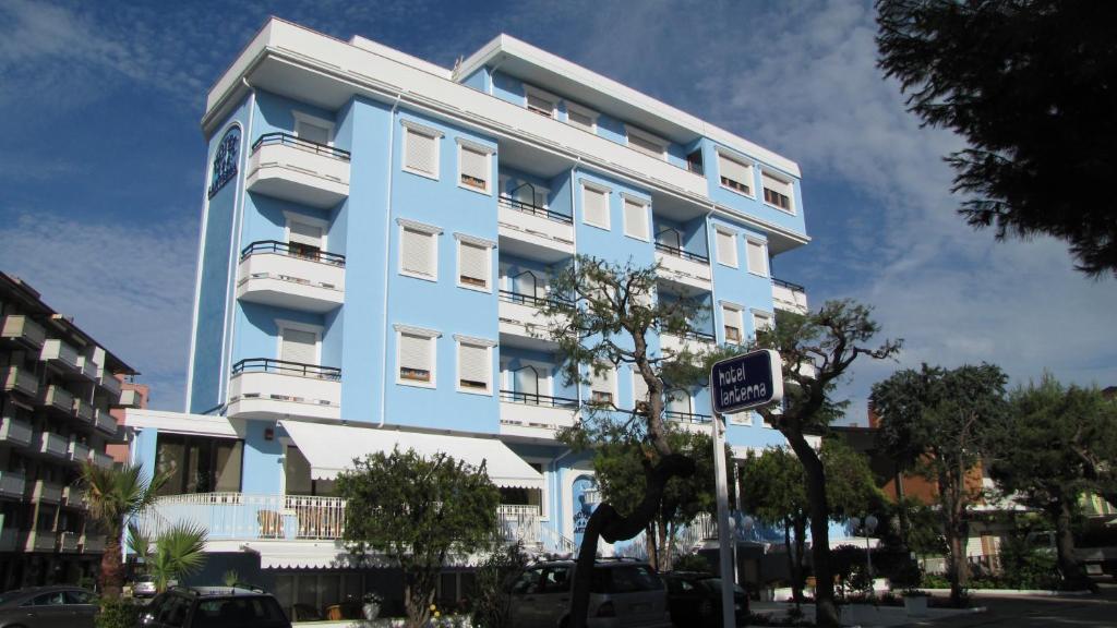 a blue and white building with a sign in front of it at Hotel Lanterna in Porto San Giorgio