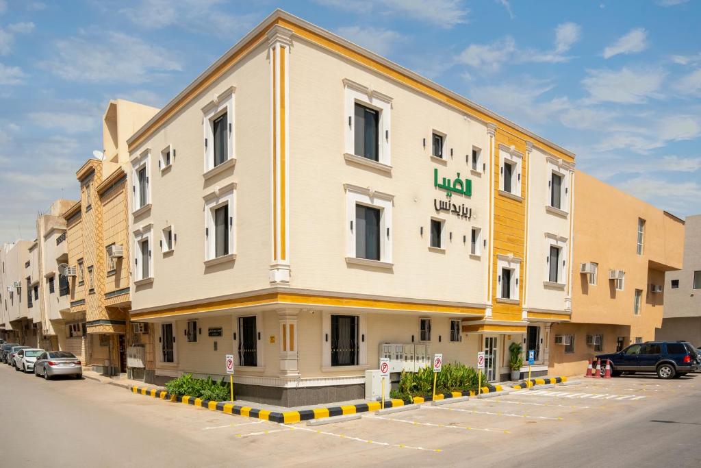 a large building with a parking lot in front of it at شقق لافيدا الفندقية in Riyadh