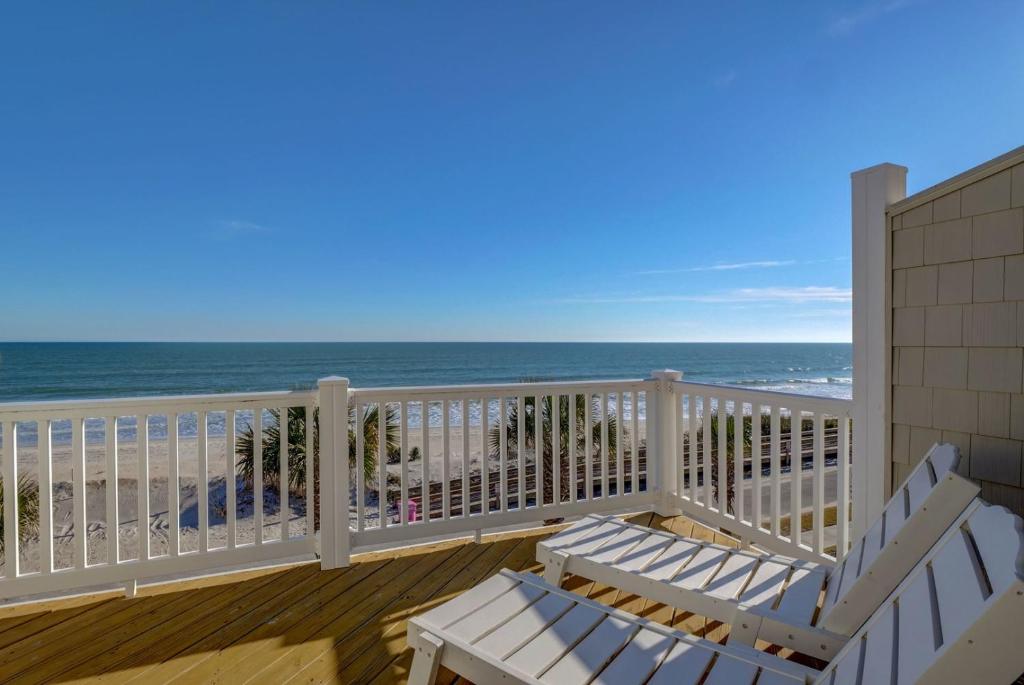 a balcony with two white chairs and the ocean at Sea Star Village 320 in West Onslow Beach