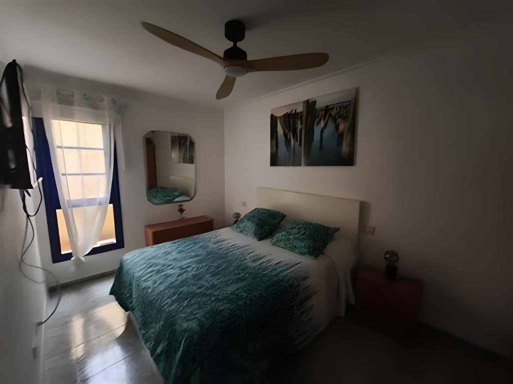Łóżko lub łóżka w pokoju w obiekcie Apartamento Tanzanita