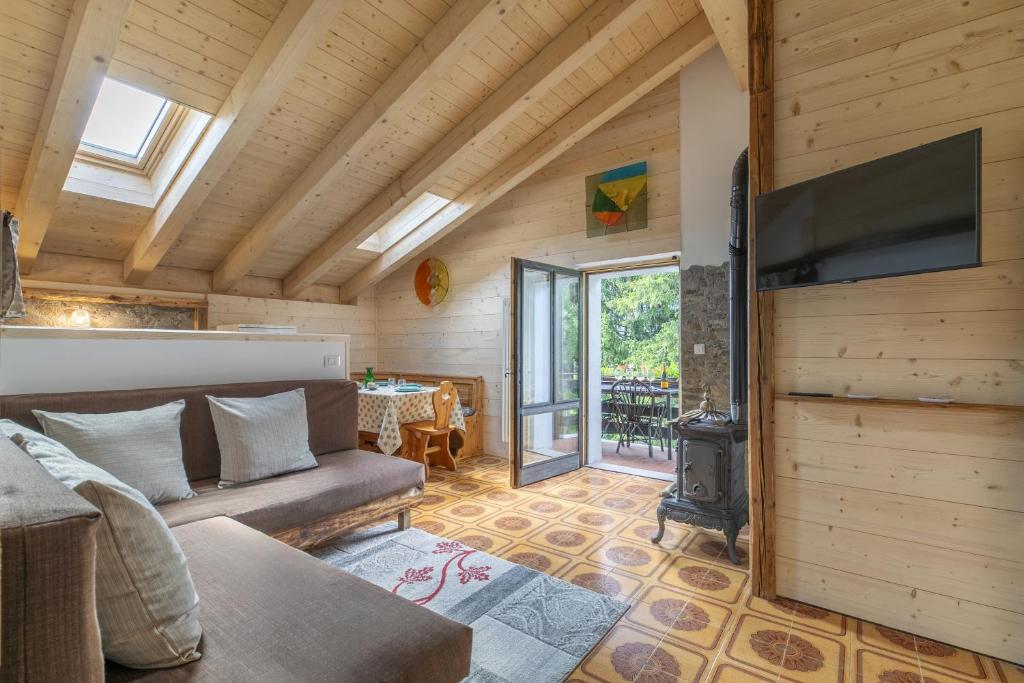 a living room with a couch and a flat screen tv at Garden Apartment Relax in Barco