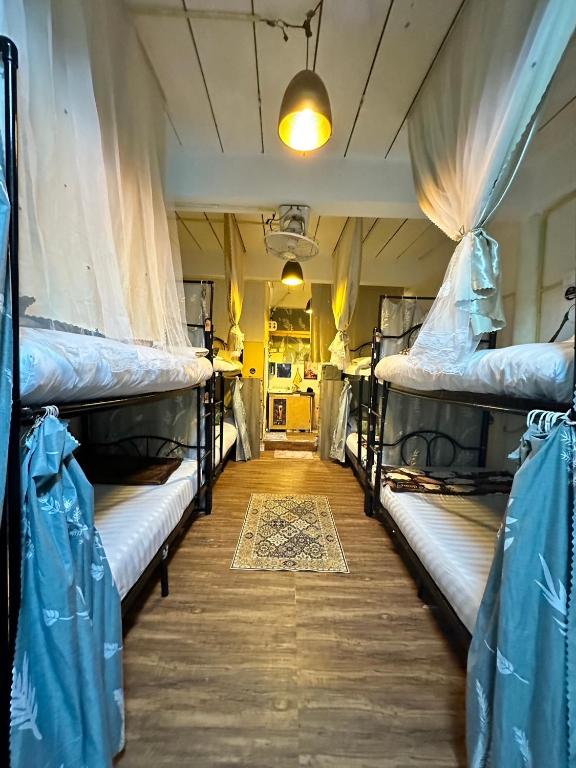 two bunk beds in a room with a hallway at MINUM hostel in Ban Madua Wan