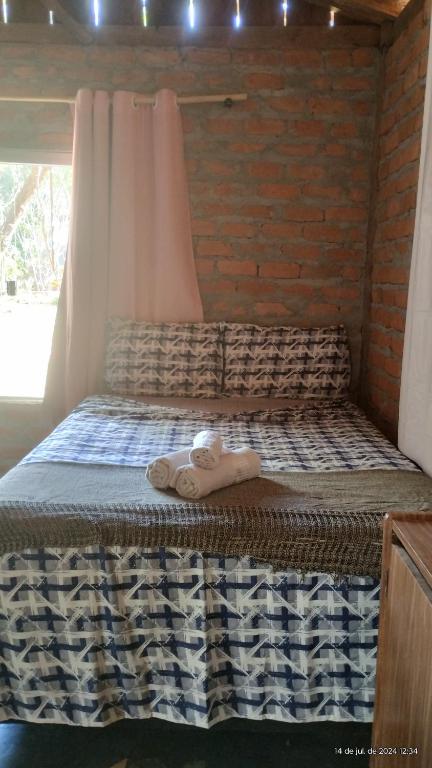 Ένα ή περισσότερα κρεβάτια σε δωμάτιο στο Camping e pousada dos sonhos