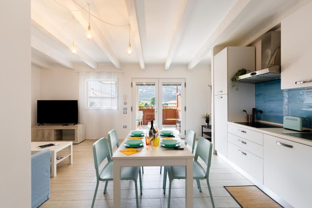 a kitchen and dining room with a table and chairs at Conca d'Oro Apartments, appartamento 5 e 6 in Arco
